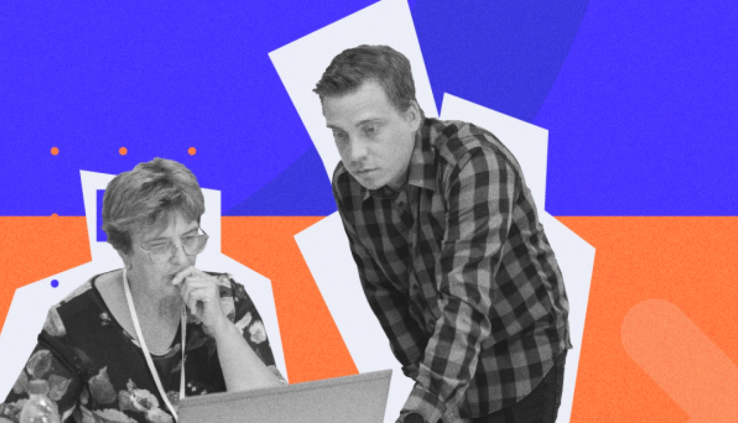 Vecāks cilvēks pie datora ar jaunāku cilvēku pāri plecam